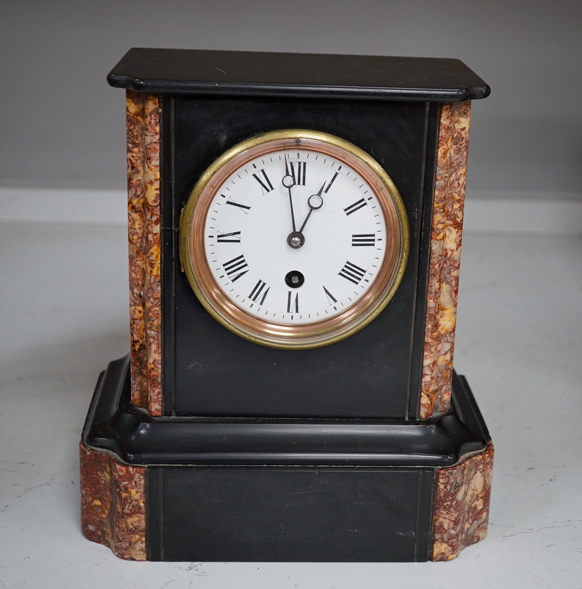 A slate mantel clock and a miniature bracket timepiece, slate clock 25cm high. Condition - miniature bracket time piece, polish on top worn,slate clock has fine scratch.